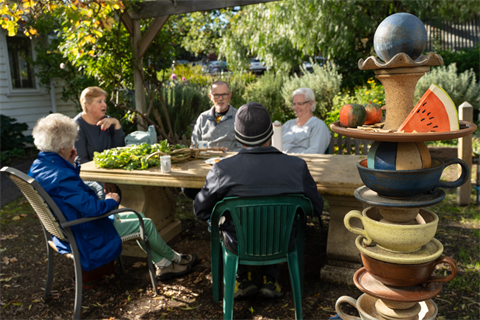 A group of people sitting outside