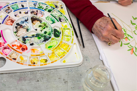 A person painting leaves