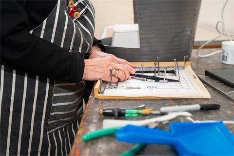 Person creating a leadlight artwork