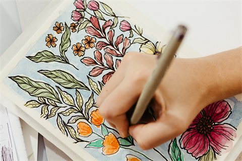 Person sketching flowers